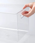 Hand holding deep plastic storage bin with built-in handles for cube shelving in office, closet, cabinet, bedroom, bathroom, nursery or dorm.