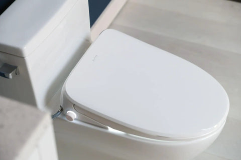 Top Shelf Elongated Bidet Toilet Seat In Crisp White With An Ultra Low Profile Setup and warm water features visible.