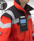 Worker wearing red jacket with Four Gas Portable Gas Detector With LCD Display Pro Grade Rechargeable Battery clipped on chest.