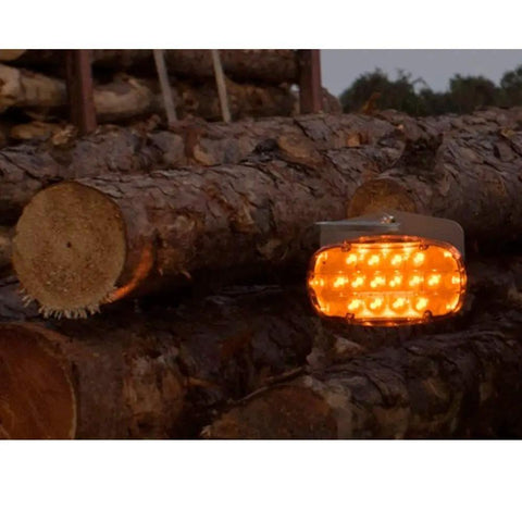 Logger Lite Safety Kit For Trucks And Logging Crews Amber Beacon With 26 LEDs on logs illuminated at dusk