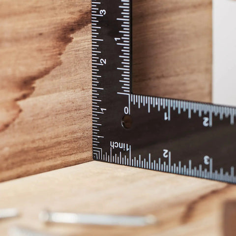 Close-up of Metal Carpenter Square Ruler L Shape Right Angle 8 By 12 Inch with Imperial and Metric Measurements in use