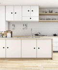 Modern kitchen with white cabinets featuring Black Round Cabinet Knobs Set Of 50 Pieces, 1.2 Inch Diameter, installed with 1 inch screws.