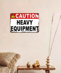 Caution Heavy Equipment Safety Sign With Funny Aluminum Wall Decor, 8x12 Inch displayed on a beige wall