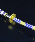 Close-up of Totally Badass 10 Inch Anime Samurai Sword Replica Katana Made From Zinc Alloy, gold tsuba detail, purple and white handle.