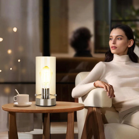 Sleek Dope Touch Control Bedside Lamp With 3 Way Dimmable Brightness next to woman on armchair in living room