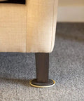 Heavy Duty Round Plastic Carpet Furniture Sliders Glide Your Couch Tables And Dressers Smooth As Butter Pads 3.5 Inches Wide Four Pack Browns under a sofa leg on carpet.