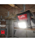 Beast Dual Power 4000 Lumen LED Flood Light mounted on a ceiling in a jobsite with corded and cordless operation, three brightness modes.