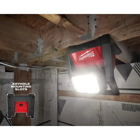 Beast Dual Power 4000 Lumen LED Flood Light mounted on a ceiling in a jobsite with corded and cordless operation, three brightness modes.