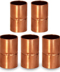 Solid Two Point Five Inch Straight Copper Coupling With Sweat Ends And Rolled Tube Stop, five pieces displayed.