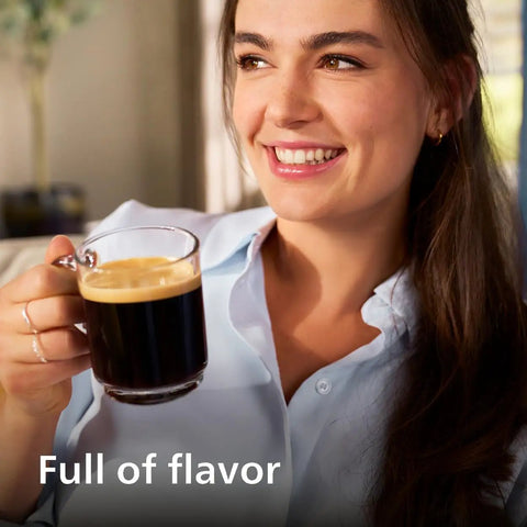 Woman enjoying a cup of coffee made with Fully Automatic Espresso Coffee Maker With LatteGo Milk Frother And Ceramic Grinder For Smooth Daily Brewing At Home.