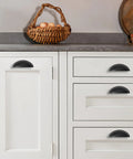 Matte Black Cabinet Cup Pulls Two And A Half Inch Center To Center Pack Of 10 installed on white kitchen cabinets