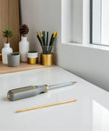 Desk with 4 Piece Solid Brass Rod Kit For DIY Makers And Craft Projects showing one brass rod next to tools and pens