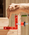 Using Sixteen Piece Right Angle Clamp Set for Woodworking with 90 Degree Positioning Squares on wooden frame.