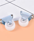 Six Piece Pack Of One Inch Universal Furniture Casters In Bright White Impact Resistant Nylon With Heavy Duty One Way Plate Mount For Built Tough Performance And Super Smooth Rolling On Hard Floors Daily close-up of two casters with steel mounts on a light background.