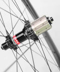 Close-up of Novatec straight pull hub and Sapim CX Ray spokes on carbon road bike wheelset 40mm deep tubeless ready rim 25mm wide