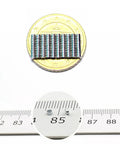 Tiny Neodymium Disc Magnets 2mm Diameter By 1mm Thick Nickel Coated Rare Earth Magnets, 0.06kg Pull, Pack Of 100 shown with coin size reference