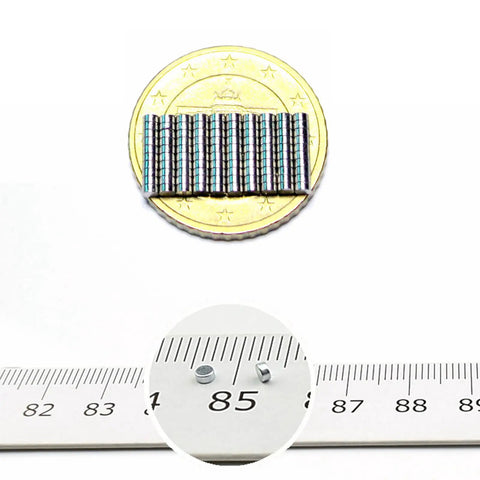Tiny Neodymium Disc Magnets 2mm Diameter By 1mm Thick Nickel Coated Rare Earth Magnets, 0.06kg Pull, Pack Of 100 shown with coin size reference