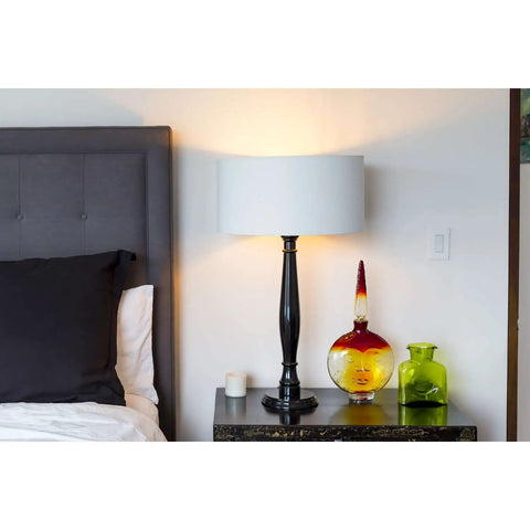 Bedroom scene with a lit 9W LED Light Bulbs 60W Equivalent, 800 Lumens, 5000K Natural Daylight in a table lamp on nightstand.
