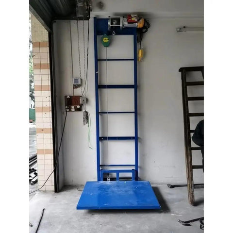 Rock Solid Steel Electric Cargo Lift Platform With Smooth Monorail Hoist For Warehouse And Home Use Effortlessly Moves Up To 200 Kgs with blue steel base.