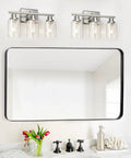 Killer 3 Light Wall Sconces With Clear Glass Shade And Brushed Nickel Finish above a mirror for bathroom vanity lighting.