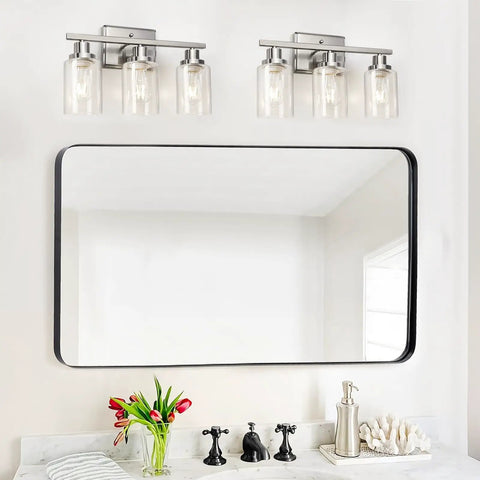 Killer 3 Light Wall Sconces With Clear Glass Shade And Brushed Nickel Finish above a mirror for bathroom vanity lighting.