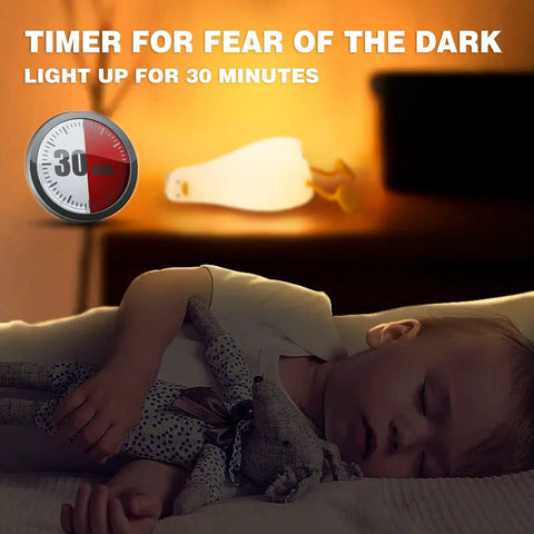Flat Lying Duck Night Light For Kids Soft Silicone Nursery Lamp with timer glowing beside sleeping child.