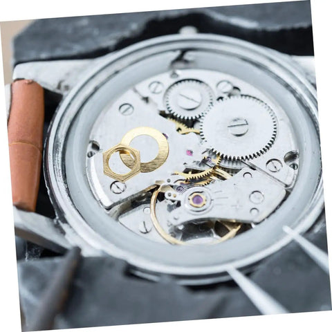 Gold 14 Piece DIY Clock Parts Kit For Metal Quartz Clock Repair includes nuts and washers on clock gears close-up