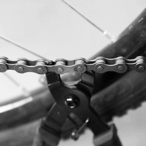 Bike Chain Tool Set Pro Grade 2 In 1 Chain Breaker And Master Link Pliers with chain on a bicycle wheel