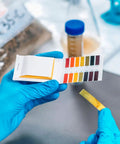 Person using All In One Soil And Water Test Paper Kit With 80 Strips Full Range 1 To 14 Color Cards Easy Dip Test for analysis.