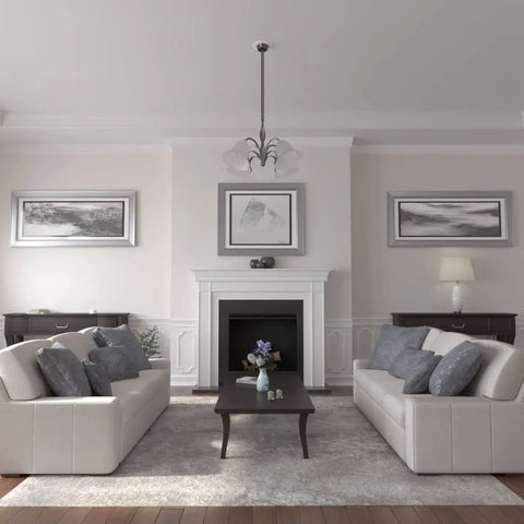 Living room with white sofas, dark wood table, fireplace, wall art, and hanging light fixture around Claremont Ceiling Medallion Nine Inch Outer Diameter, Inner Opening Four and a Half Inches, One Half Inch Projection, Lightweight Primed Finish for Easy DIY Install, Includes Canopy, Can Be Cut Drilled Glued or Screwed With Common Tools.