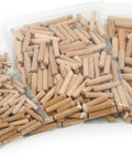 Top Shelf Kiln Dried Birch Dowel Pins in three bags, assorted sizes for furniture repair and workshop builds.