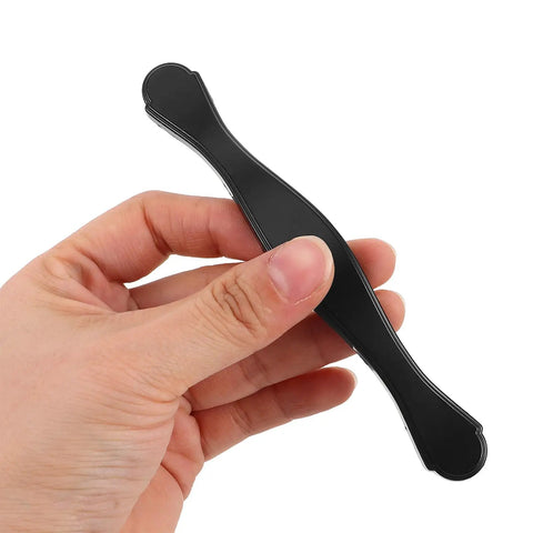 Hand holding a single black metal handle from Black Kitchen Cabinet Hardware Pulls 10 Pack Modern Drawer Handles Replacement for Cabinets Furniture Cupboards and Doors Sleek Boss Pulls for Dressers and Cabinet Doors with Easy Install.
