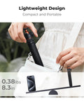 Person placing Mini Selfie Stick Tripod Stand With Five Adjustable Levels And 360 Degree Ball Head Pocket Tripod in bag