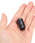 Hand holding Beefy Rigid Shaft Coupling With Set Screws Five Eighths Inch Bore One And A Quarter Inch Outside Diameter Two Inch Length Black