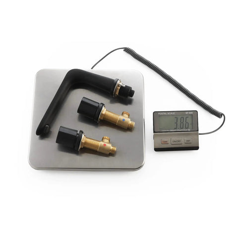 Three Piece Widespread Bathroom Faucet With 3 Holes Deck Mount Matte Black Finish next to digital scale