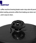 Close-up of black plastic spring-loaded coffee machine stop valve kit on a glossy lid; fits Mr. Coffee/Black & Decker