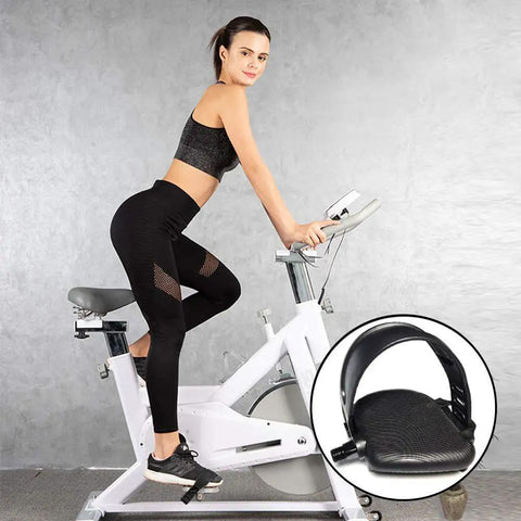 Woman using exercise bike with two pairs go-to durable exercise bike pedal straps with adjustable length for spinning and stationary bikes.