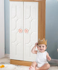 Child smiling in front of cabinet with 4 Piece Pink Petal Drawer Knobs With Bling Centers Spark A Major Bedroom Glow Up Solid Zinc Alloy Cabinet Hardware For Dresser And Closet Upgrade Top Notch Girls Room Decor.