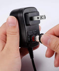 All In One 12W Universal AC DC Adapter with Eight Swappable Tips, showing tip being attached to power supply.