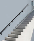Flush Wall Mounted Stainless Steel Handrail Featuring Heavy Duty Sleek Black Cylinder With Rock Solid Grip And Knockout Antislip Coating Built Tough For Secure Stair Support And Everyday Hallway Use on staircase.