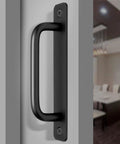 Close-up of heavy duty black barn door handle on a flat surface, featuring aluminum material and smooth grip design for easy use.