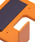 Close-up of Magnetic Hinge Jig With Precise Adjustable Clamps for cabinet doors and deck installations, orange ABS body.