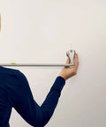 Person installing Hamden Spot Resist Brushed Nickel 24 Inch Single Towel Bar with easy install feature on wall.