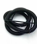 Badass Stretchy Coil Extension Cord With Heavy Duty Spiral Spring Design Hella Flexible Telescopic Power Wire Expanding Fifty Foot Range For Trucks And Shop Tools coiled up for easy storage.