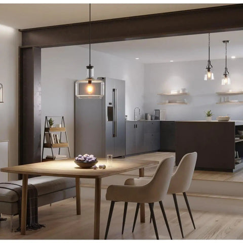Latrobe Collection 1 Light Clear Glass Coastal Pendant Light In Matte Black illuminating modern dining area