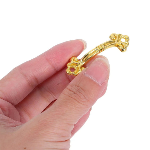 Hand holding a 12 Pack Vintage Gold Cabinet Pull for Small Drawers and Jewelry Boxes, mini dope retro handle, durable metal hardware