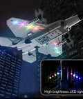 F22 Style 4 Channel RC Airplane with Xpilot Stabilization flying at night, featuring colorful LED lights and dual battery pack.