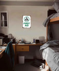 Funny Safety Sign 8x12 Inch Aluminum Wall Decor for bedroom, metal sign with "First Aid" message on wall.