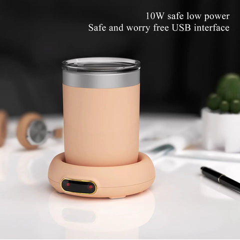 Keep Your Daily Brew Sizzling Hot This Smart Coffee Mug Warmer Uses An Ultra Smooth Metal Heating Base With Gravity Activated Control For Zero Fuss Desk Enjoyment with USB interface and soft pink base.