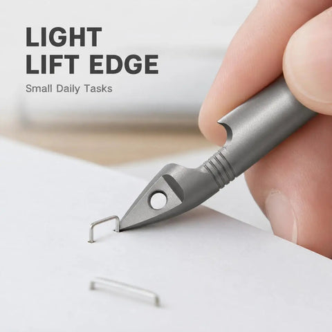 Close-up of Mini Pencil EDC Pendant with Infinite Keychain lifting staple, demonstrating pocket-sized writing tool use for small tasks.